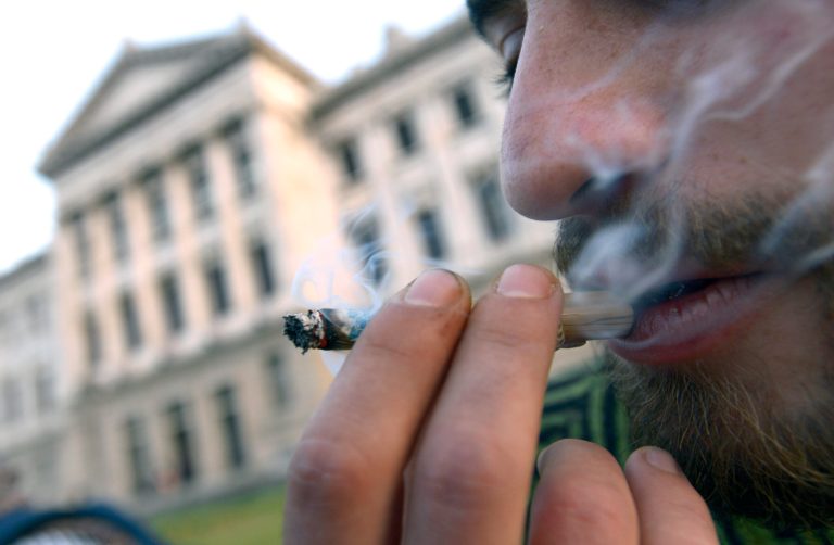 A man smokes marijuana outside Uruguay's Congress in Montevideo, Uruguay, in July 2013. (AP Photo/Matilde Campodonico)
