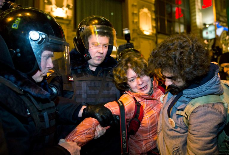 Russian police officers detain people in Manezhnaya Square, next to Red Square, during an unauthorized protest against the conviction of eight anti-government protesters in Moscow onÃÂ Monday, where hearings started against opposition activists detained on May 6, 2012, during a rally at Bolotnaya Square. (AP/Evgeny Feldman)
