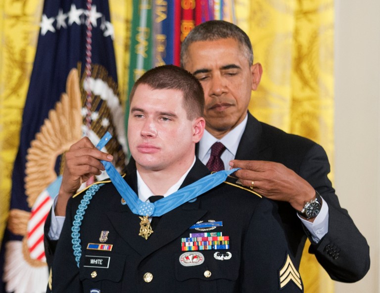 President Barack Obama awards the Medal of Honor to former Army Sgt. Kyle J. White during a ceremony in the East Room of the White House in Washington, Tuesday, May 13, 2014. White is a former Army sergeant who saved a fellow soldier's life and helped secure the evacuation of other wounded Americans while under persistent fire during a 2007 ambush in Afghanistan. White is the seventh living recipient to be awarded the Medal of Honor for actions in Iraq or Afghanistan. (AP Photo)