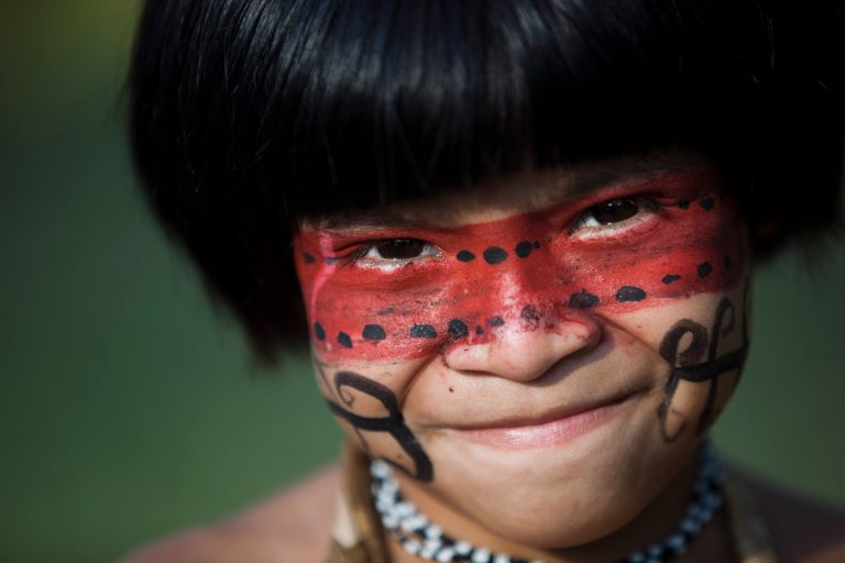   A boy of the Guarani Kaiowa tribe poses for a photo at the Kari-Oca village, where indigenous from around the world are staying during the United Nations Conference on Sustainable Development, or Rio+20, in Rio de Janeiro, Brazil, Wednesday, June 13, 2012. The Rio+20 conference is expected to draw some 50,000 participants including delegates, environmental activists, business leaders and indigenous groups. The event runs through June 22, with three final days of high-profile talks among some 130 top leaders from nations around the globe. (AP Photo/Felipe Dana)  