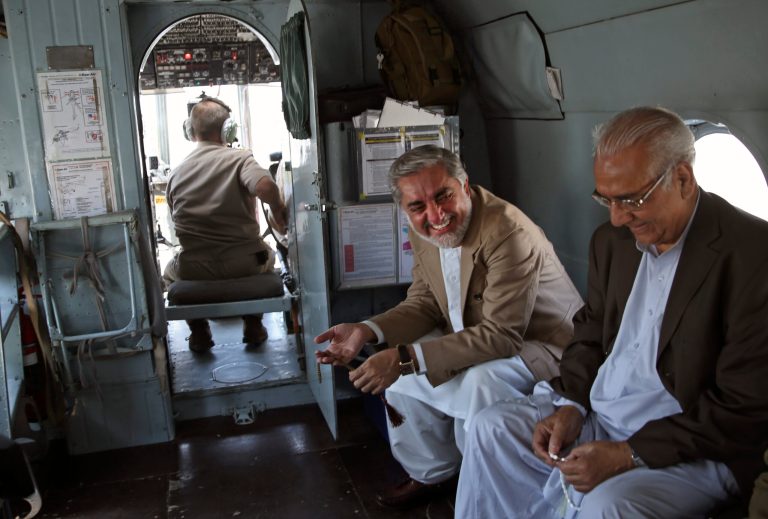 Afghani presidential candidate Abdullah Abdullah, center, talks to his colleagues aboard a helicopter heading to a campaign rally in Ghazni, Afghanistan, Tuesday, June 3, 2014. The second round of Afghanistan's presidential election will take place on June 14, 2014. (AP Photo/Massoud Hossaini)
