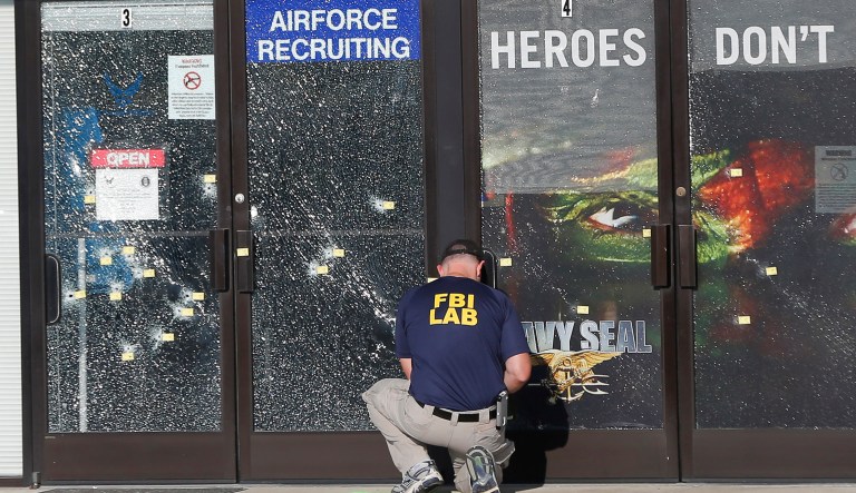 In this July 17, 2015, file photo, an FBI investigator investigates the scene of a shooting outside a military recruiting center in Chattanooga, Tenn. Last week, President Trump referred to the deadly shooting as an example of a 