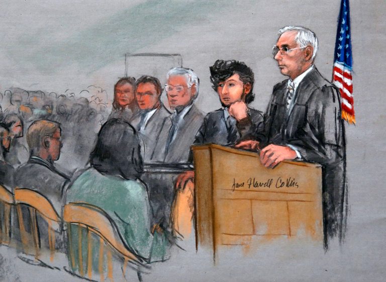 In this courtroom sketch, Boston Marathon bombing suspect Dzhokhar Tsarnaev, second from right, is depicted with his lawyers, left, beside U.S. District Judge George O'Toole Jr., right, as O'Toole addresses a pool of potential jurors in a jury assembly room at the federal courthouse, Monday, Jan. 5, 2015, in Boston. (AP Photo/Jane Flavell Collins)
