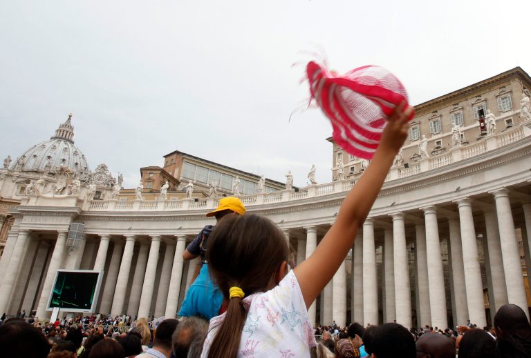 A child waves to Pope Francis, top right, during the Angelus prayer noon in St. Peter's square at the Vatican, Sunday, June 15, 2014. (AP Photo/Riccardo De Luca)