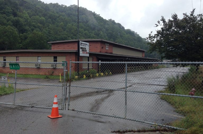 This  Aug. 8, 2014 photo shows barbed wire and a no trespassing sign tell people to stay away from the George F. Johnson Elementary School in Pike County, Ky. The school district closed the school last year because of declining enrollment. The district merged it with two other schools to create a new school that runs from Kindergarten to eighth grade. (AP Photo/Adam Beam)