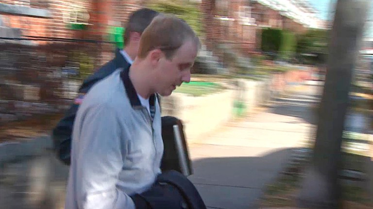 In this image taken from video and released by WJLA TV, U.S. Postal police walk with Ryan Loskarn, center, chief of staff for U.S. Sen. Lamar Alexander, Wednesday, Dec. 11, in Washington D.C. (AP Photo/WJLA TV)