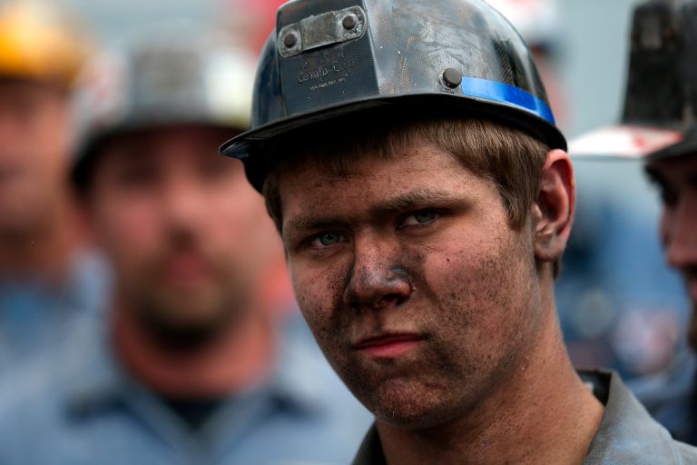 A coal miner looks on during a campaign rally at American Energy Corportation on August 14, 2012 in Beallsville, Ohio. (Photo by Justin Sullivan/Getty Images)