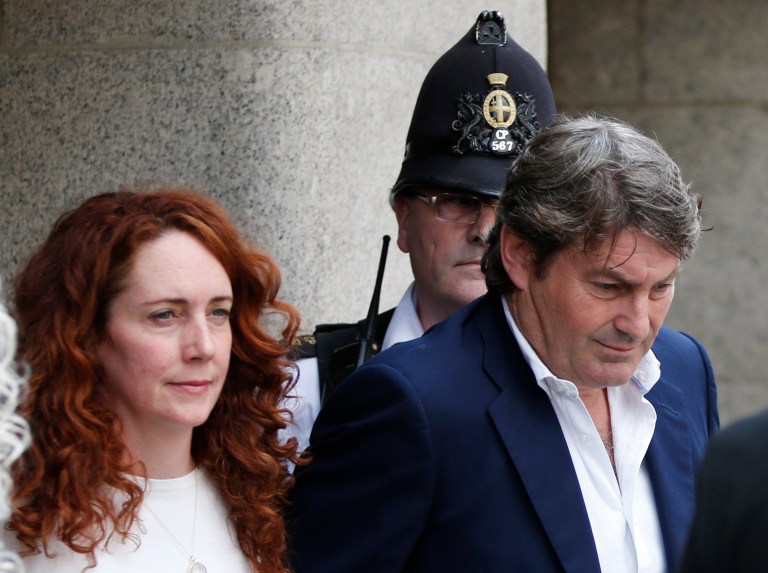 Rebekah Brooks, former News International chief executive, left, accompanied by her husband Charlie Brooks, leaves the Central Criminal Court in London, Tuesday, June 24, 2014. Former News of the World editor Andy Coulson was convicted of phone hacking Tuesday, but fellow editor Rebekah Brooks was acquitted after a months-long trial centering on illegal activity at the heart of Rupert Murdoch's newspaper empire. A jury at London's Old Bailey unanimously found Coulson, the former spin doctor of British Prime Minister David Cameron, guilty of conspiring to intercept communications. Brooks was acquitted of that charge and of counts of bribing officials and obstructing police. The nearly eight-month trial was triggered by revelations that for years the News of the World used illegal eavesdropping to get stories, listening in on the voicemails of celebrities, politicians and even crime victims. (AP Photo/Lefteris Pitarakis)
