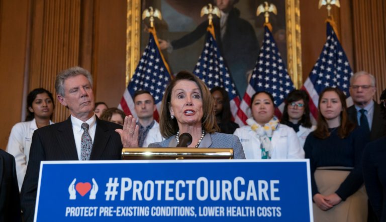 Speaker of the House Nancy Pelosi, joined at left by Energy and Commerce Committee Chair Frank Pallone, speaks at an event to announce legislation to lower health care costs and protect people with pre-existing medical conditions.