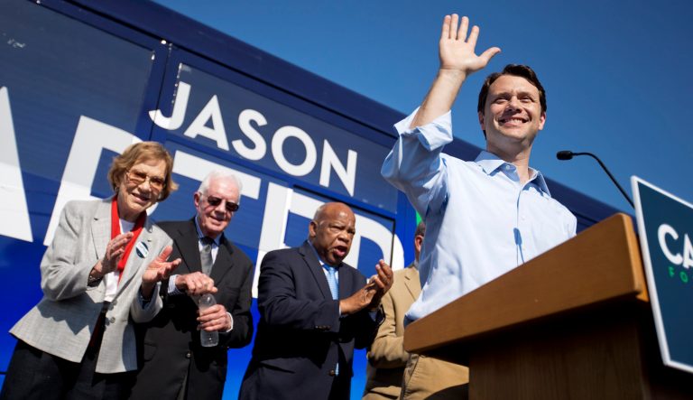 Georgia Democratic gubernatorial candidate Jason Carter, right, waves to the crowd during a campaign stop