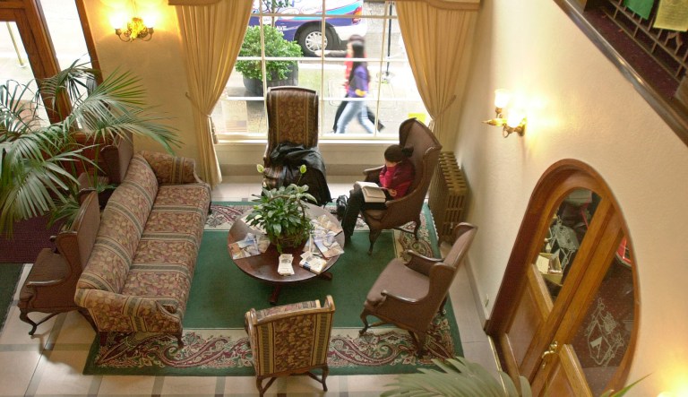 A guest reads in the lobby at the City Center hostel in San Francisco. 