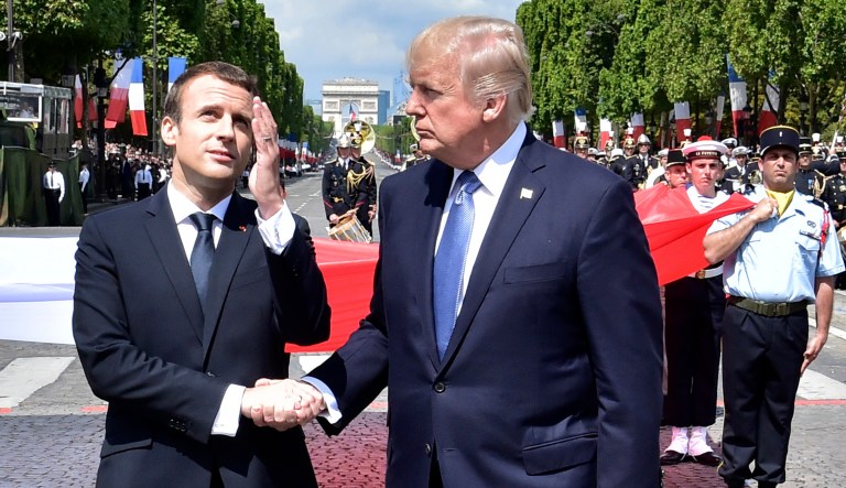 French President Emmanuel Macron shakes hands with President Trump after the Bastille Day military parade. Trump said Macron is "a great guy  smart, strong, loves holding my hand." 