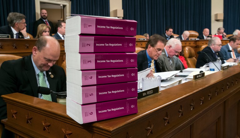 Volumes of tax regulations are stacked on the dais as the House Ways and Means Committee begins the markup process of the GOP's far-reaching tax overhaul. When Congress is strapped for the expertise necessary to keep its members informed on legislative proposals like tax reform, special interests will fill the void, particularly when votes are forced under harsh time constraints. (AP Photo/J. Scott Applewhite)