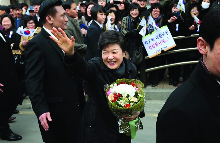South Korea's new President Park Geun-hye waves to supporters while leaving her private residence for her inauguration ceremony at the National Assembly in Seoul, South Korea, Monday, Feb. 25, 2013. Park has become South Korea's first female president and returned to the presidential mansion where she grew up with her dictator father. (AP Photo/Yonhap, Shin Jun-hee) KOREA OUT