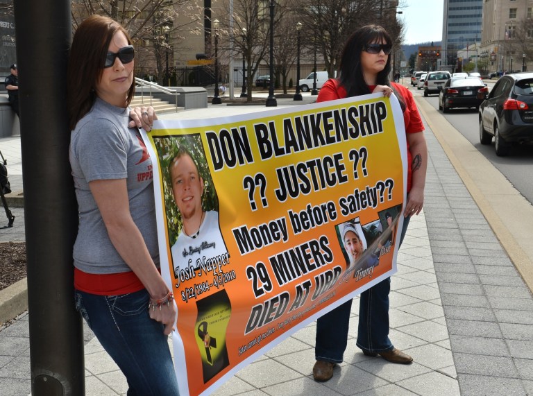 Friends and families of the 29 victims of the Upper Big Branch Mine explosion gather in front of the Robert C. Byrd Federal Courthouse in Charleston, W.Va., Wednesday April 2, 1014. Wednesday's gathering commemorated the disaster. Saturday is the four-year anniversary of the explosion.  (AP Photo/Charleston Daily Mail, Craig Cunningham)