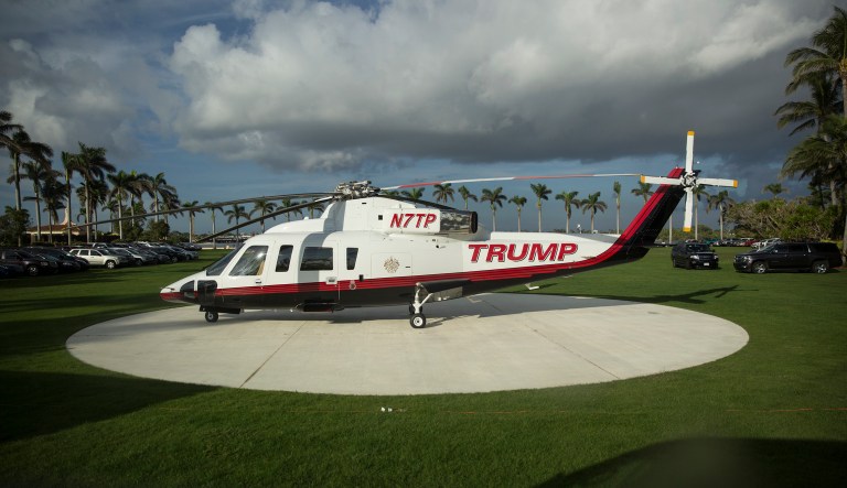 The Trump helicopter is seen through the window of the media van on its helipad at President Donald Trump's Mar-a-Lago estate in Palm Beach, Fla., Saturday, Dec. 23, 2017. (AP Photo/Carolyn Kaster)