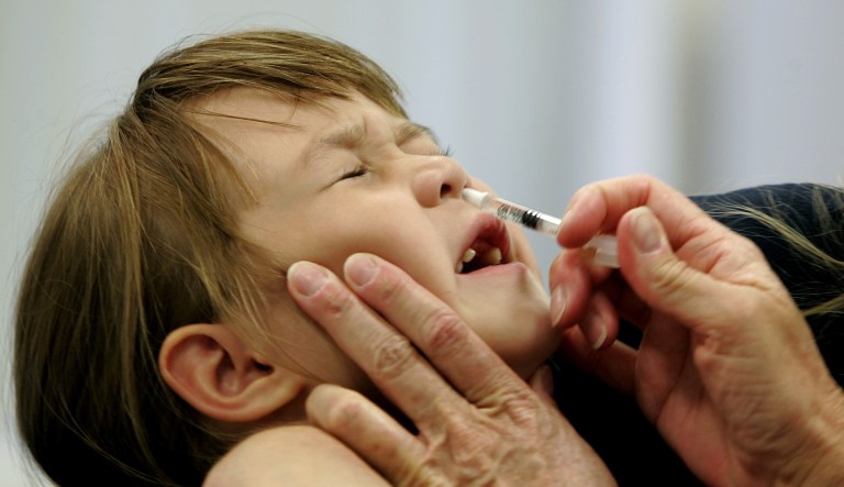 In this 2005 file photo, Danielle Holland reacts as she is given a FluMist influenza vaccination in St. Leonard, Md. The Advisory Committee on Immunization Practices, part of the Centers for Disease Control and Prevention, voted 12-2 Wednesday to recommend that doctors administer the flu vaccine via nasal spray. (AP Photo/Chris Gardner, File)