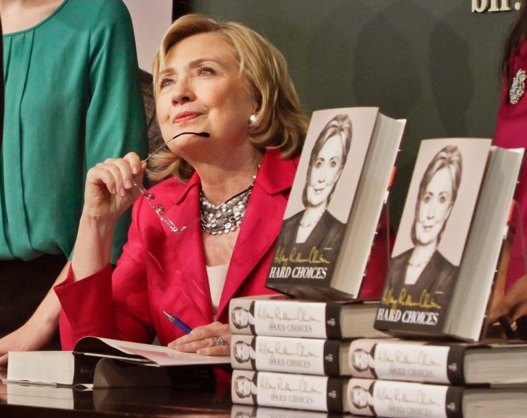 HiIlary Clinton listens before signing a copy of her book on Tuesday, at a bookstore in New York. (AP Photo/Bebeto Matthews)