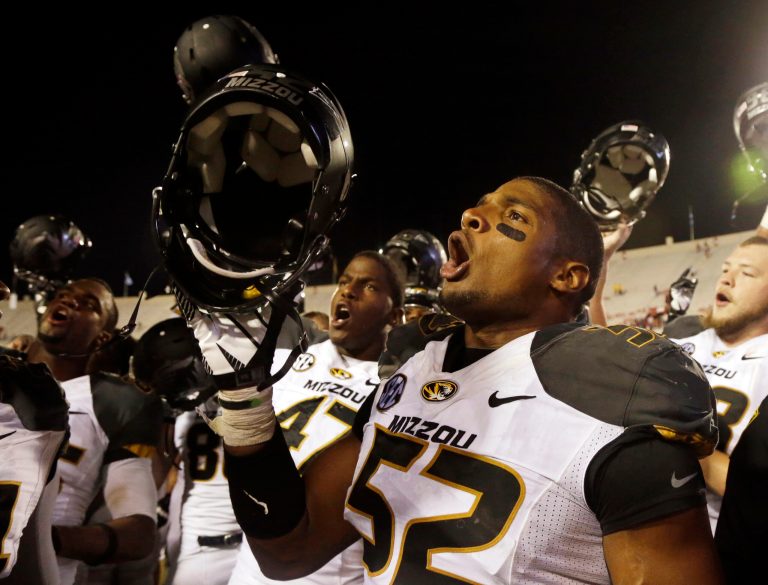 FILE - In this Sept. 21, 2013, file photo, Missouri's Michael Sam (52) sings the school song after Missouri defeated Indiana in an NCAA college football game in Bloomington, Ind. The All-American athlete says he is gay, and the defensive end could become the first openly homosexual player in the NFL. (AP Photo/Darron Cummings, File)