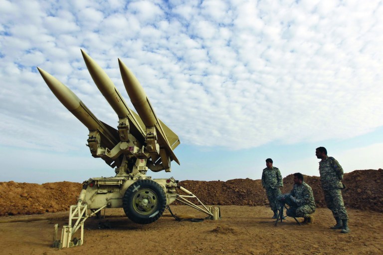 FILE - In this Nov. 13, 2012 file photo obtained from the Iranian Mehr News Agency, Iranian army members prepare missiles to be launched, during a maneuver, in an undisclosed location in Iran. President Barack Obama may have to decide this year whether to use military force to fulfill his vow to prevent Iran from being able to build nuclear weapons, foreign policy experts say. But America's economic and military realities argue intensely against attacking the Islamic Republic and for muddling through by, perhaps, further tightening sanctions that have cut deeply into Tehran's economy. (AP Photo/Mehr News Agency, Majid Asgaripour, File)