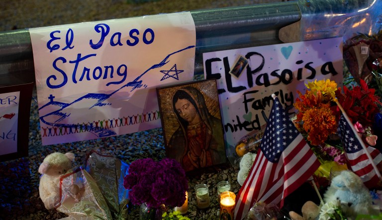 A Virgin Mary painting, flags and flowers adorn a makeshift memorial for the victims of Saturday's mass shooting at a shopping complex in El Paso, Texas, Sunday, Aug. 4, 2019.