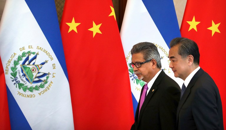 El Salvador's Foreign Minister Carlos Castaneda, left, and China's Foreign Minister Wang Yi walk together for a signing ceremony to mark the establishment of diplomatic relations between the two countries at the Diaoyutai State Guesthouse in Beijing Tuesday, Aug. 21, 2018. Taiwan broke off diplomatic ties with El Salvador on Tuesday as the Central American country defected to rival Beijing in the latest blow to the self-ruled island China has been trying to isolate on the global stage.
