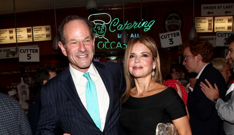 Eliot Spitzer, left, and Roxana Girand, right, attend New York Magazine's 50th Anniversary Celebration at Katz's Delicatessen on Tuesday, Oct. 24, 2017, in New York.