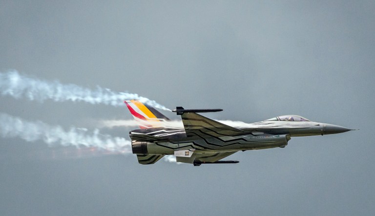 FILE - In this Wednesday, May 18, 2016 file photo, a Belgian F16 fighter jet flies over Florennes Military Airbase, in Florennes, Belgium.