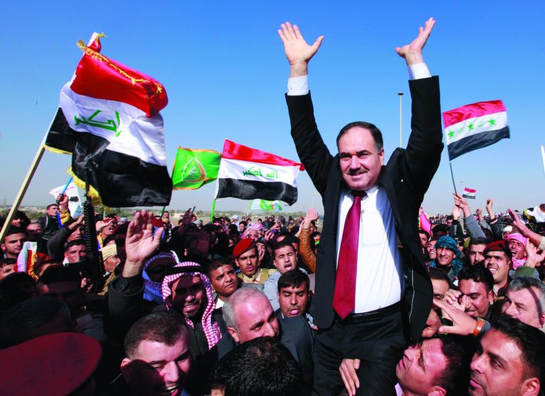 Iraq's Finance Minister Rafia al-Issawi is carried by his supporters during a demonstration in Ramadi, 70 miles (115 kilometers) west of Baghdad, Iraq, Wednesday, Dec. 26, 2012. Thousands of Iraqi demonstrators massed in a Sunni-dominated province west of Baghdad Wednesday, determined to keep up the pressure on a Shiite-led government that many accuse of trying to marginalize them. (AP Photo/ Hadi Mizban)