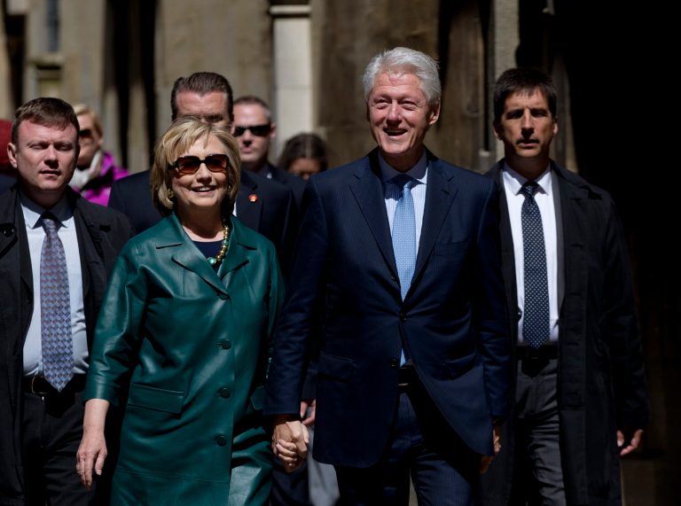 Former U.S. President Bill Clinton, center right, and his wife former Secretary of State Hillary Rodham Clinton, center left, walk away after they attended their daughter Chelsea's Oxford University graduation ceremony held at the Sheldonian Theatre in Oxford, England, Saturday, May 10, 2014. (AP Photo/Matt Dunham)