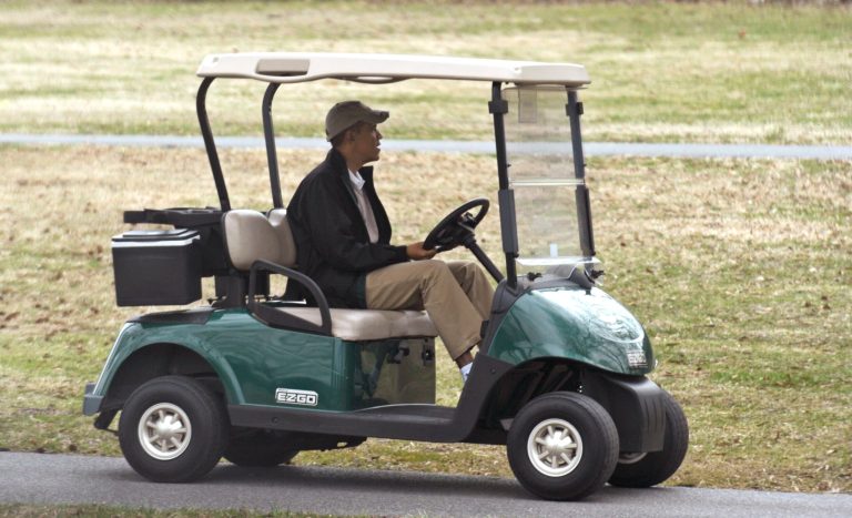 President Obama drives a golf cart as he arrives to play golf at Andrews Air Force Base in Md., Saturday, March 22, 2014. (AP Photo/Susan Walsh)