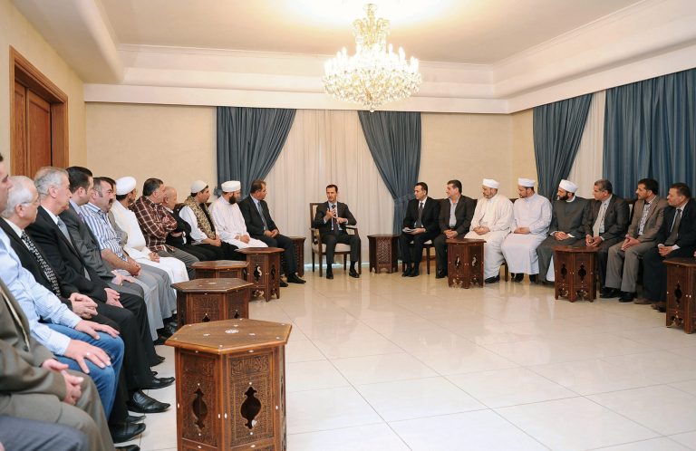 In this photo released by the Syrian official news agency SANA, Syrian President Bashar Assad, center, speaks during his meeting with secular and religious dignitaries from Damascus suburbs, in Damascus, Syria, Saturday, May 31, 2014. Syrian rebels blew up a tunnel packed with explosives in the northern Syrian city of Aleppo on Friday, killing at least 20 pro-government fighters, activists and rebels said. (AP Photo/SANA)