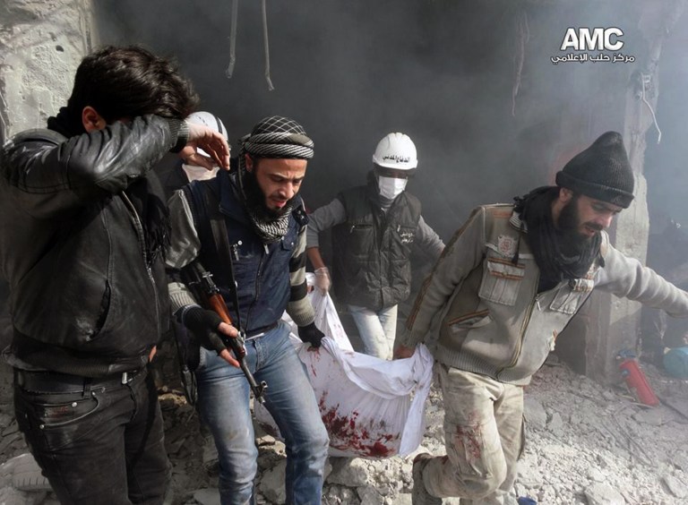 In this citizen journalism image provided by Aleppo Media Center (AMC), an anti-Bashar Assad activist group, which has been authenticated based on its contents and other AP reporting, Syrian residents and rescue workers carry a body from a building damaged by the Syrian forces airplanes in the neighborhood of Qadi Askar in Aleppo, Syria, Thursday, Jan. 30, 2014. The Aleppo Media Center said the air raid killed and wounded several people. (AP Photo/Aleppo Media Center, AMC)