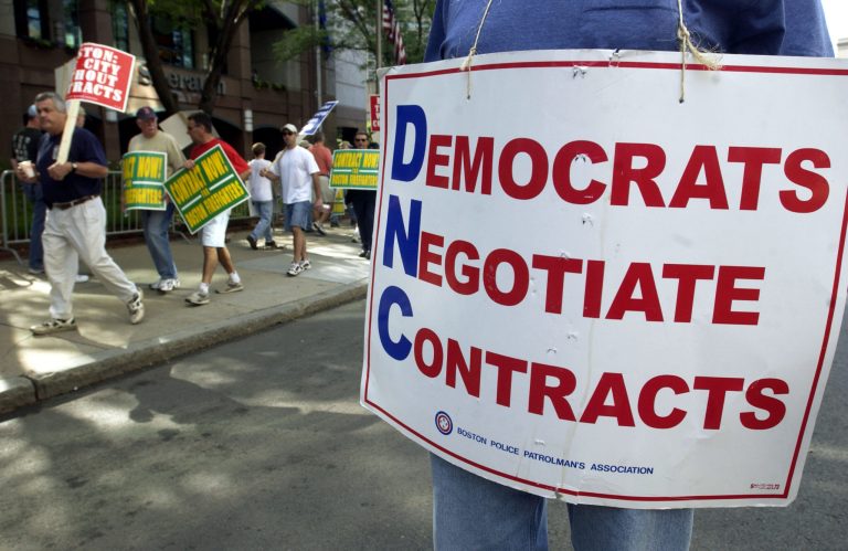 Members of the Boston Police Patrolmen's Association walk a picket line outside the Boston Sheraton Hotel, where the U.S. Conference of Mayors is holding their convention June 28, 2004 in Boston, Massachusetts. (Photo by Darren McCollester/Getty Images)