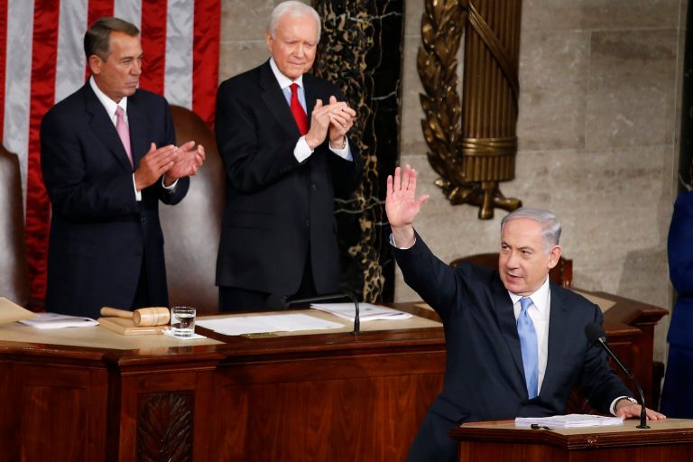 Israeli Prime Minister Benjamin Netanyahu waves as he step to the podium prior to speaking before a joint meeting of Congress on Capitol Hill in Washington, Tuesday, March 3, 2015. Prime Minister Netanyahu is using the address to warn against trusting Iran to curb its nuclear ambitions. House Speaker John Boehner of Ohio, left, and Sen. Orrin Hatch, R-Utah, applaud.  (AP Photo/Andrew Harnik)