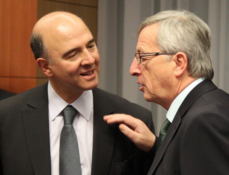   French Finance Minister Pierre Moscovici, left, talks with Luxembourg's Prime Minister and chairman of the Eurogroup Jean-Claude Juncker, during the Eurogroup meeting, at the European Council building in Brussels, Monday, Dec. 3, 2012. Details of a plan for Greeceâs to reduce its heavy debt by buying some of it back at bargain prices will be presented Monday in Brussels to finance ministers from the 17 European Union countries that use the euro. (AP Photo/Yves Logghe)  