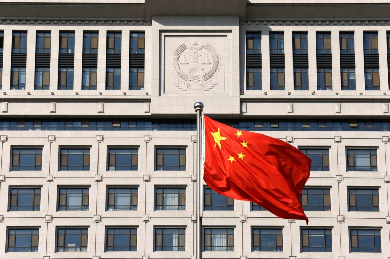 A Chinese national flag billows in front of a building of Shandong Province Supreme People's Court in Jinan, in eastern China's Shandong province. (AP/Alexander F. Yuan)