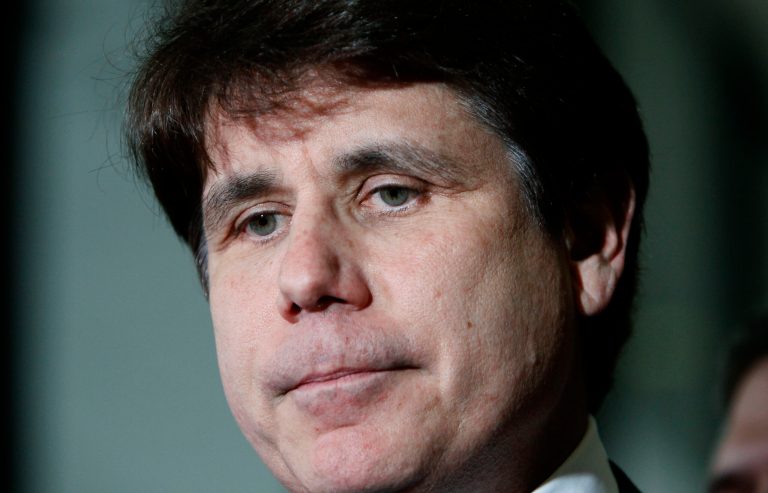 Former Illinois Gov. Rod Blagojevich talks with reporters at the Federal Court building after the judge handed the case to the jury in his corruption trial in Chicago, in June 2011. (AP Photo/Charles Rex Arbogast, File)