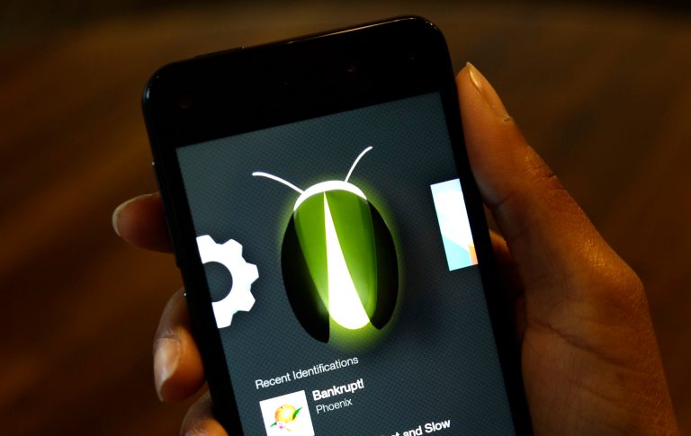 The new Amazon Fire Phone's Firefly feature, which lets the user take a photo of objects, numbers, artwork or books and have the phone recognize the item, is demonstrated, Wednesday, June 18, 2014, in Seattle. Firefly also can recognize songs, TV shows, and movies. (AP Photo/Ted S. Warren)
