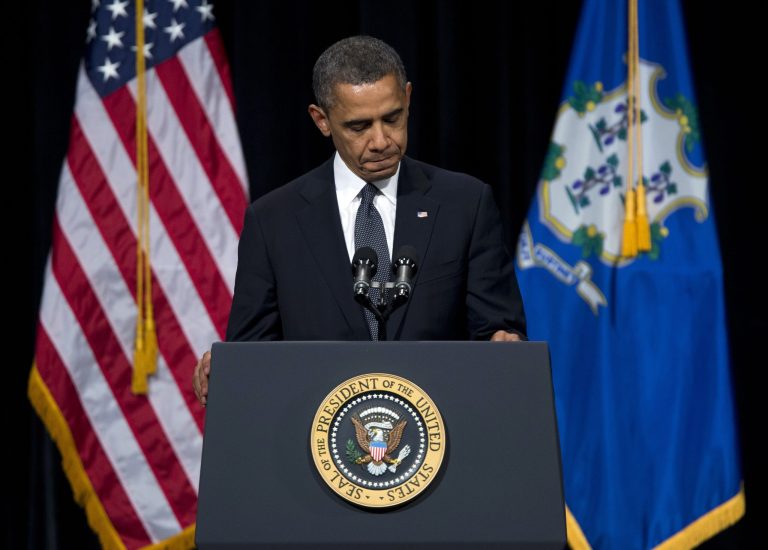   FILE - This Dec. 16, 2012 file photo shows President Barack Obama pausing during a speech at an interfaith vigil for the victims of the Sandy Hook Elementary School shooting, at Newtown High School in Newtown, Conn. A review of 2012 media reports by The Associated Press found at least 61 gun-related deaths of American children 12 or younger, not including the children slain at Sandy Hook school. They died in small batches, one or two at a time, in cities, suburbs, small towns, on Indian reservations and, frequently, at home or with parents nearby. (AP Photo/ Evan Vucci, File)  