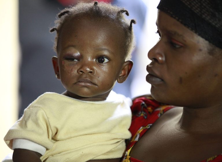 Goodness Adams, a 10-month baby, who survived Monday's bomb explosion is carried by her aunt, Grace Sabo, in an ambulance at Asokoro hospital, Abuja, to be taken to be reunited with her mother at the Wuse hospital in Abuja, Nigeria, Wednesday, April 16, 2014. The baby, lost in the chaos of the bus station bomb blast in Nigeria's capital is to be reunited Wednesday with her critically wounded mother, a Nigerian newspaper reported. Goodness, is being cared for at the hospital where it was presumed her mother was among the 75 dead victims of Monday's explosion, reported The Daily Trust. But family members found the mother, Gloria Adams, in another hospital, and her aunt has arranged the reunion. (AP Photo/Sunday Alamba)