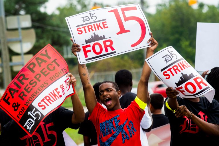About 150 protesters gather to raise minimum wage to $15 and unionize as they march around McDonald's on Stewart Avenue near Dort Highway on Thursday, Sept. 4, 2014 in Flint, Mich. (AP Photo/The Flint Journal, Jake May)