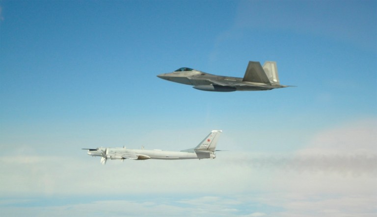 Russian Tu-95 and US F-22.