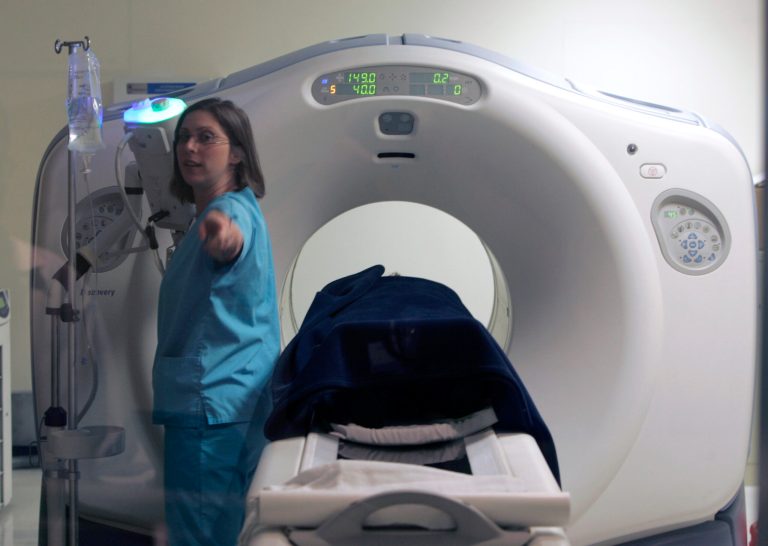 Nurse Patricia Schmidt assists with a positron emission tomography cat scan, or PET-CT, on a patient at River Radiology in Kingston, N.Y., Friday, June 15, 2007. (AP Photo/Mike Groll)