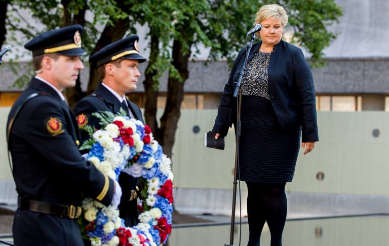 Norwegian Prime Minister Erna Solberg, attends a wreath laying ceremony near the damaged government building in Oslo Tuesday, July 22, 2014, to mark the third anniversary of twin attacks that killed 77 people in Oslo and on Utoeya Island, on July 22, 2011. Solberg said the best way to honor the 77 people who died in terror attacks three years ago is to 