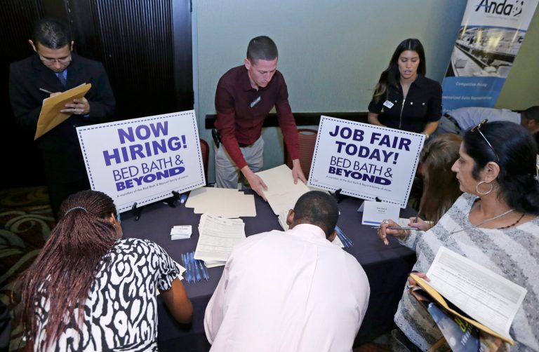Job seekers fill out a job applications at a Bed Bath and Beyond table at a job fair in Miami Lakes, Fla. (AP/Alan Diaz)