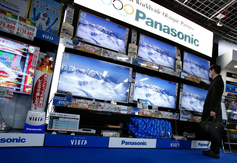 FILE - In this Feb. 4, 2014 file photo, a shopper looks at Panasonic's flat-panel televisions at an electronics retail store in Tokyo. Panasonic returned to profit after deep losses for the past two fiscal years, as a weak yen and restructuring efforts helped a gradual recovery, and forecast a 16 percent increase in gains for the coming year. The Osaka-based maker of the Lumix camera and Evolta batteries reported Monday, April 28, 120.4 billion yen ($1.2 billion) in profit for the fiscal year through March 2014, a reversal from a 754.3 billion yen loss the previous fiscal year. (AP Photo/Shizuo Kambayashi, File)