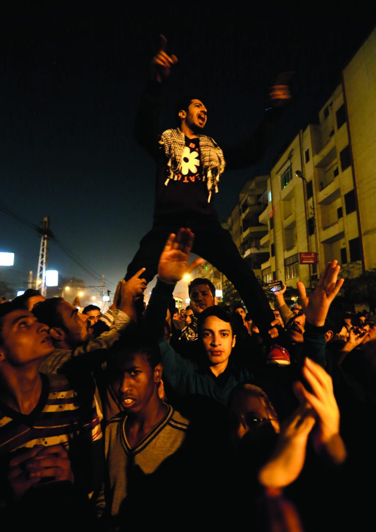 Egyptian protesters chant anti Muslim Brotherhood and Egyptian President Mosri slogans outside the presidential palace in Cairo, Egypt, Thursday, Dec. 6, 2012. The Egyptian army has deployed tanks outside the presidential palace in Cairo following clashes between supporters and opponents of Mohammed Morsi that left several people dead and hundreds wounded. (AP Photo/Hassan Ammar)