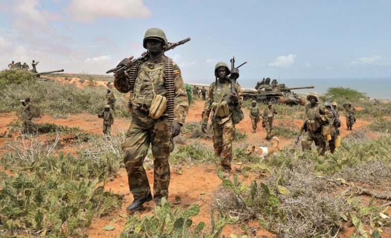 In this photo taken Sunday, Oct. 5, 2014 and provided by the African Union Mission to Somalia (AMISOM), African Union (AU) soldiers march along the top of a hill overlooking the al-Shabab stronghold of Barawe, a coastal town 220 kilometers (135 miles) southwest of Mogadishu, in Somalia. Officials in Somalia say AU and Somali troops have seized Barawe, the last major stronghold held by the Islamic militant group al-Shabab, with the AU claiming it as a significant victory because al-Shabab had used the port to bring in arms and fighters and export charcoal, a multi-million-dollar business. (AP Photo/AMISOM, Tobin Jones)