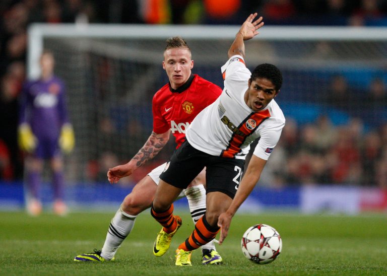 FILE - In this Tuesday, Dec. 10, 2013 file photo, Donetsk's Douglas Costa, right, gets away from Manchester United's Alexander Buttner during their Champions League group A soccer match between Manchester United and Shakhtar Donetsk at Old Trafford Stadium, Manchester, England. Six South Americans - including Costa - have refused to return to Ukraine to play for their football club in Donetsk as conflict rages around the city, risking possible fines and suspensions for breach of contract. (AP Photo/Jon Super, File)